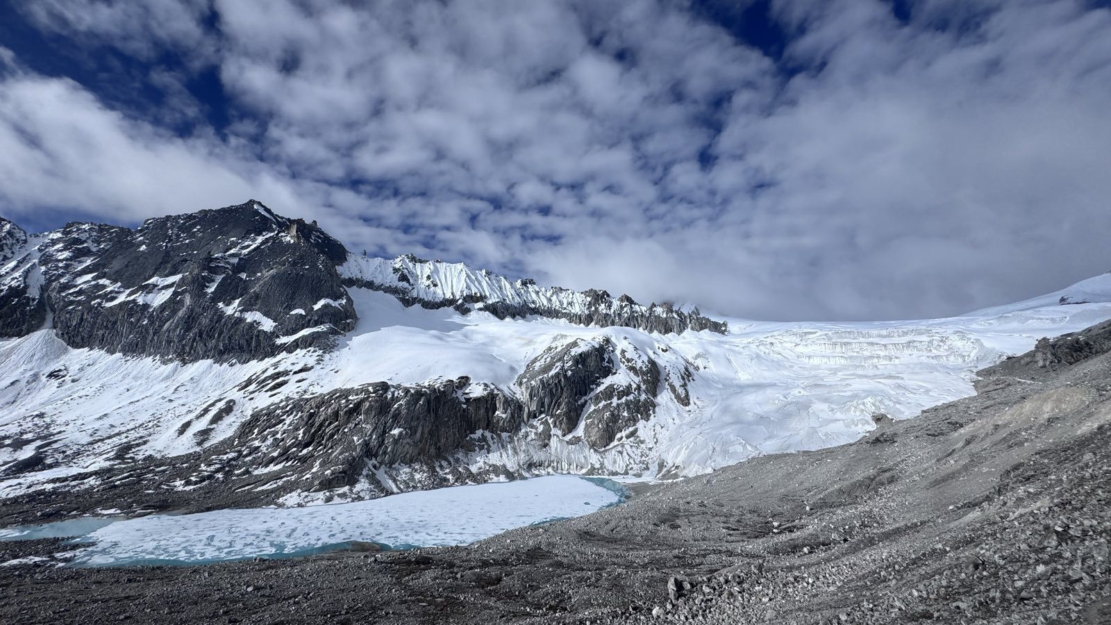 Snow peaks and a hanging glacier under blue sky on the Snowman route